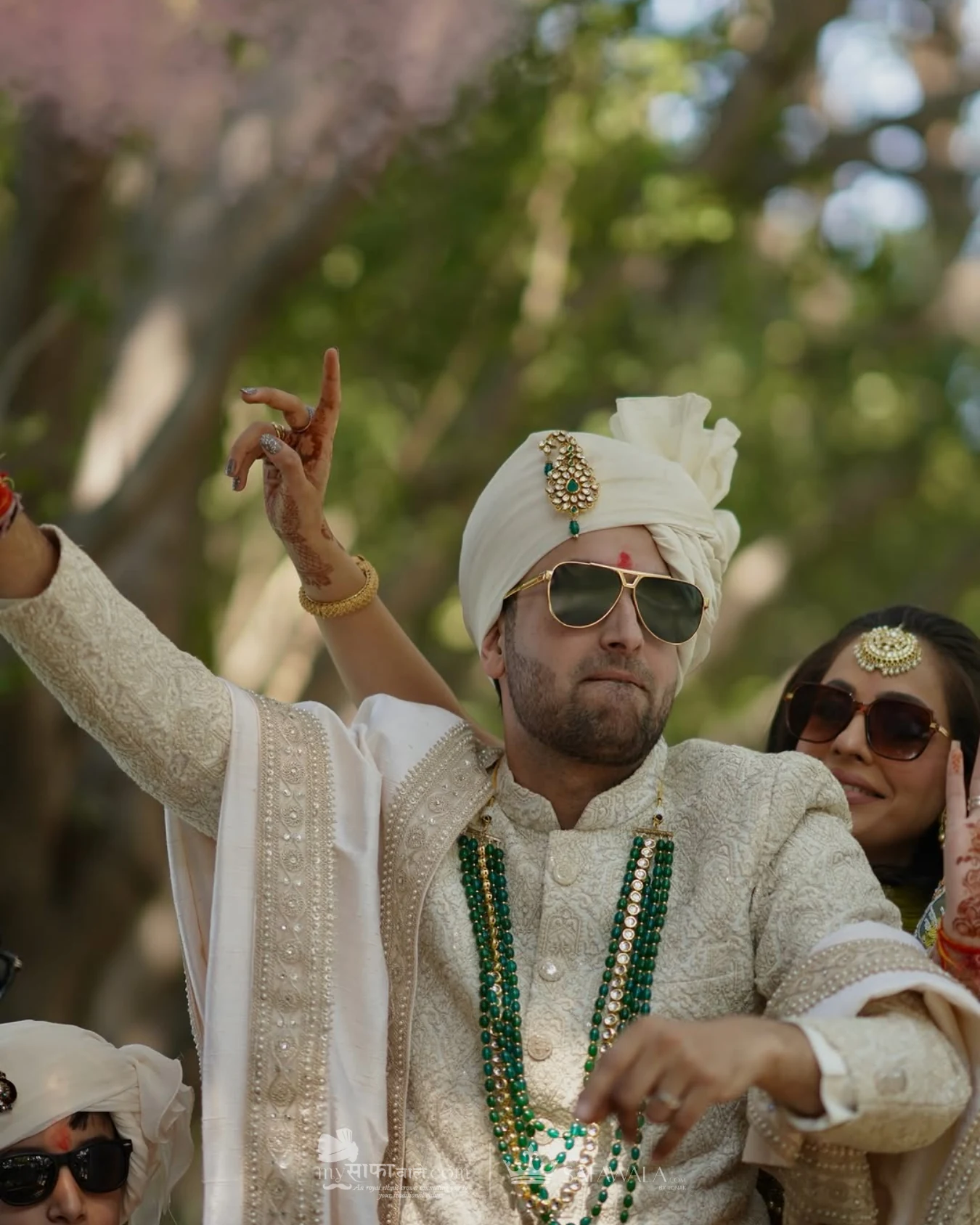 Groom in an ivory wedding safa with emerald jewellery for Bhangarwadi
